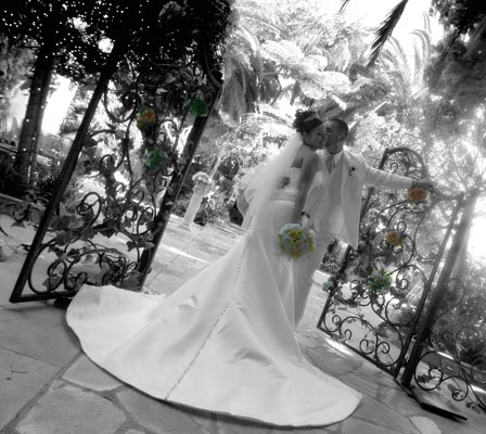 Magazine style fashion photoshoot in Orange County. Portrait of the Bride and Groom after the ceremony. The bride is in her wedding dress with a short veil and bouquet.