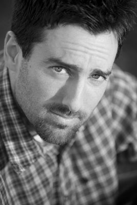 Headshot of actor in the Los Angeles area. Here he looks up at the camera in the black and white shot.