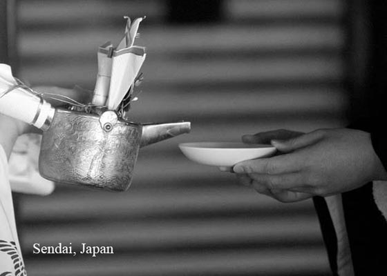 Japanese wedding where groom get's poured some tea during the wedding ceremony.